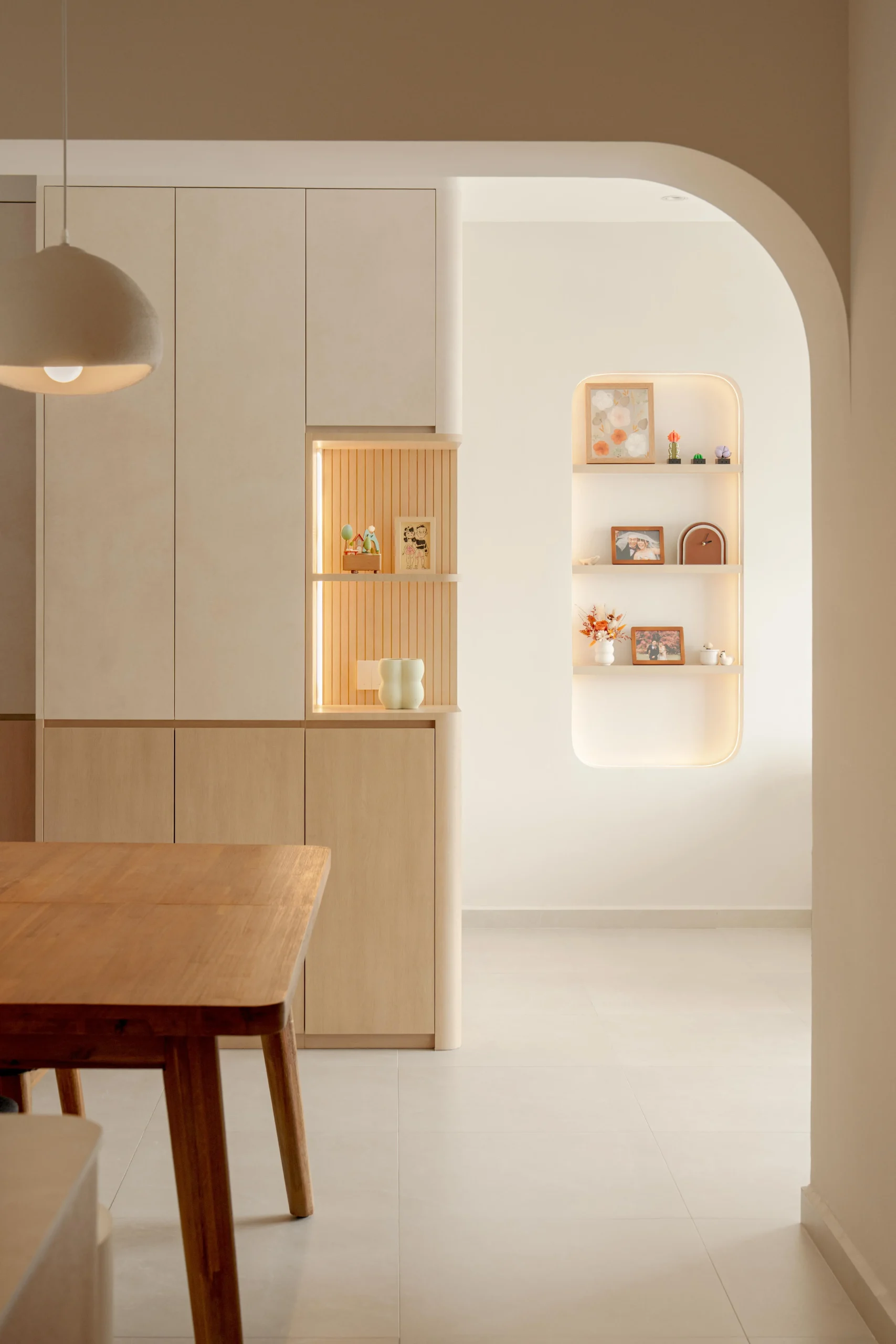 Built-in cabinetry with arched niche shelves softly lit for display.