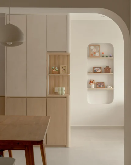 Built-in cabinetry with arched niche shelves softly lit for display.